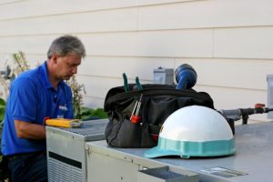 HVAC-technician-repairing-an-air-conditioner
